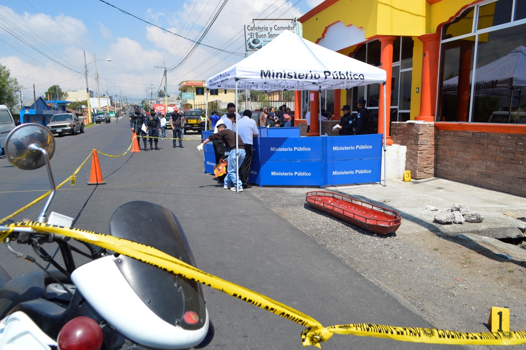Socorristas y agentes policiales resguardan lugar donde se halla cadáver de motorista, en San Pedro Sacatepéquez, San Marcos. (Genner Guzmán)