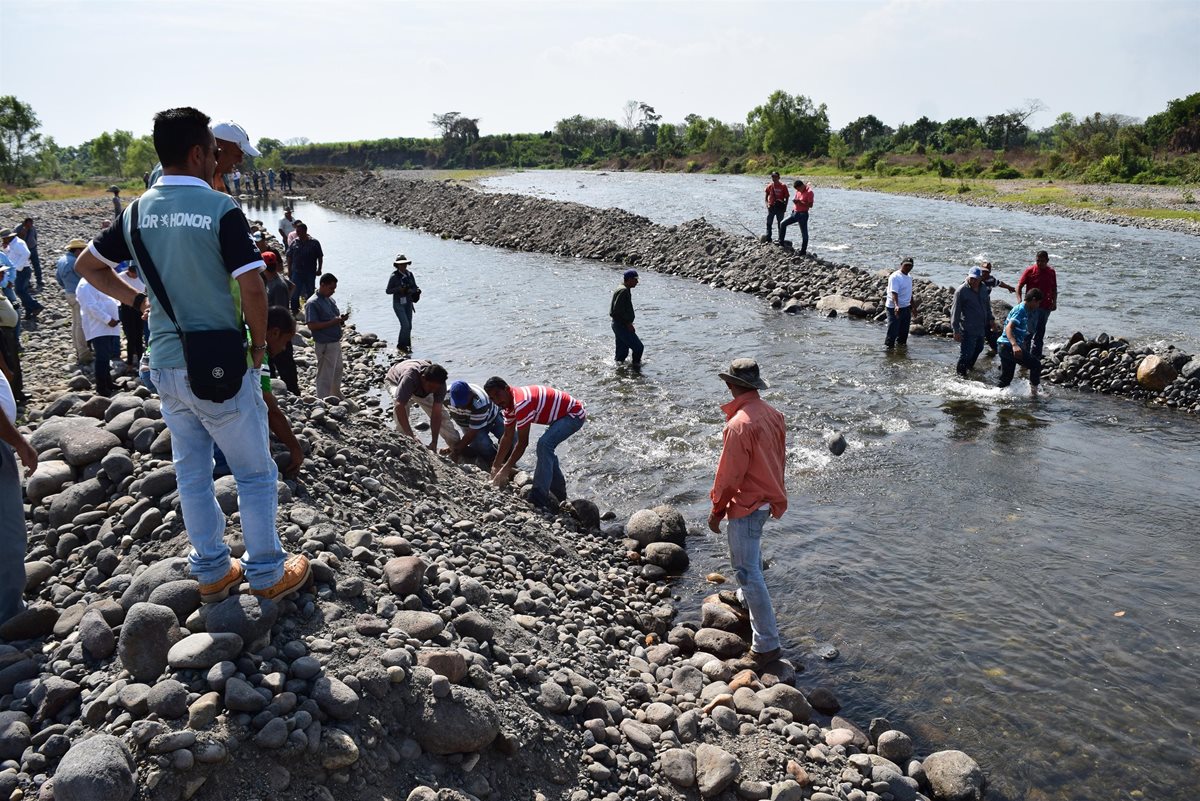 Unos 200 pobladores de Nueva Concepción, Escuintla, liberan el paso del río Madre Vieja. (Foto Prensa Libre: Carlos E. Paredes)