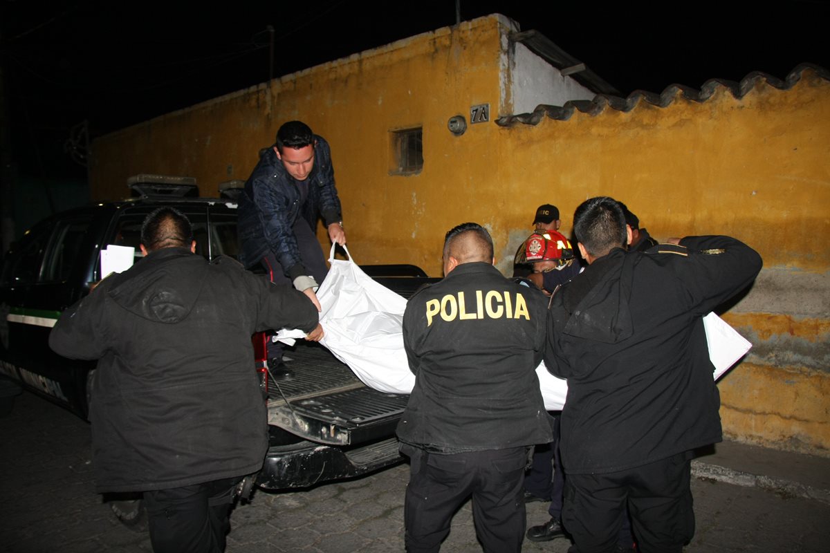 Agentes de la PNC retiran el cadáver de un hombre que fue ultimado en Jocotenango, Sacatepéquez. (Foto Prensa Libre: Renato Melgar)