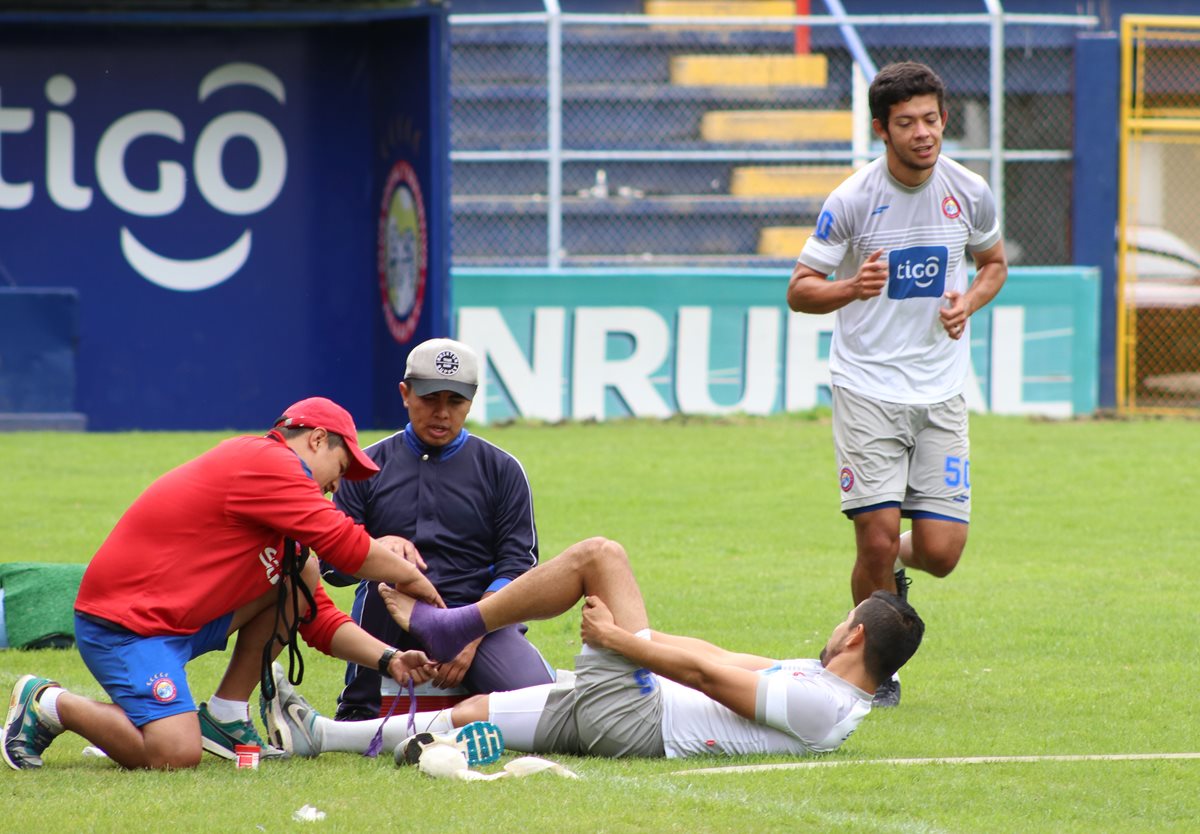 César Morales -en el suelo- y Héctor Moreira hicieron trabajo de fisioterapia para avanzar en su recuperación. (Foto Prensa Libre: Raúl Juárez)