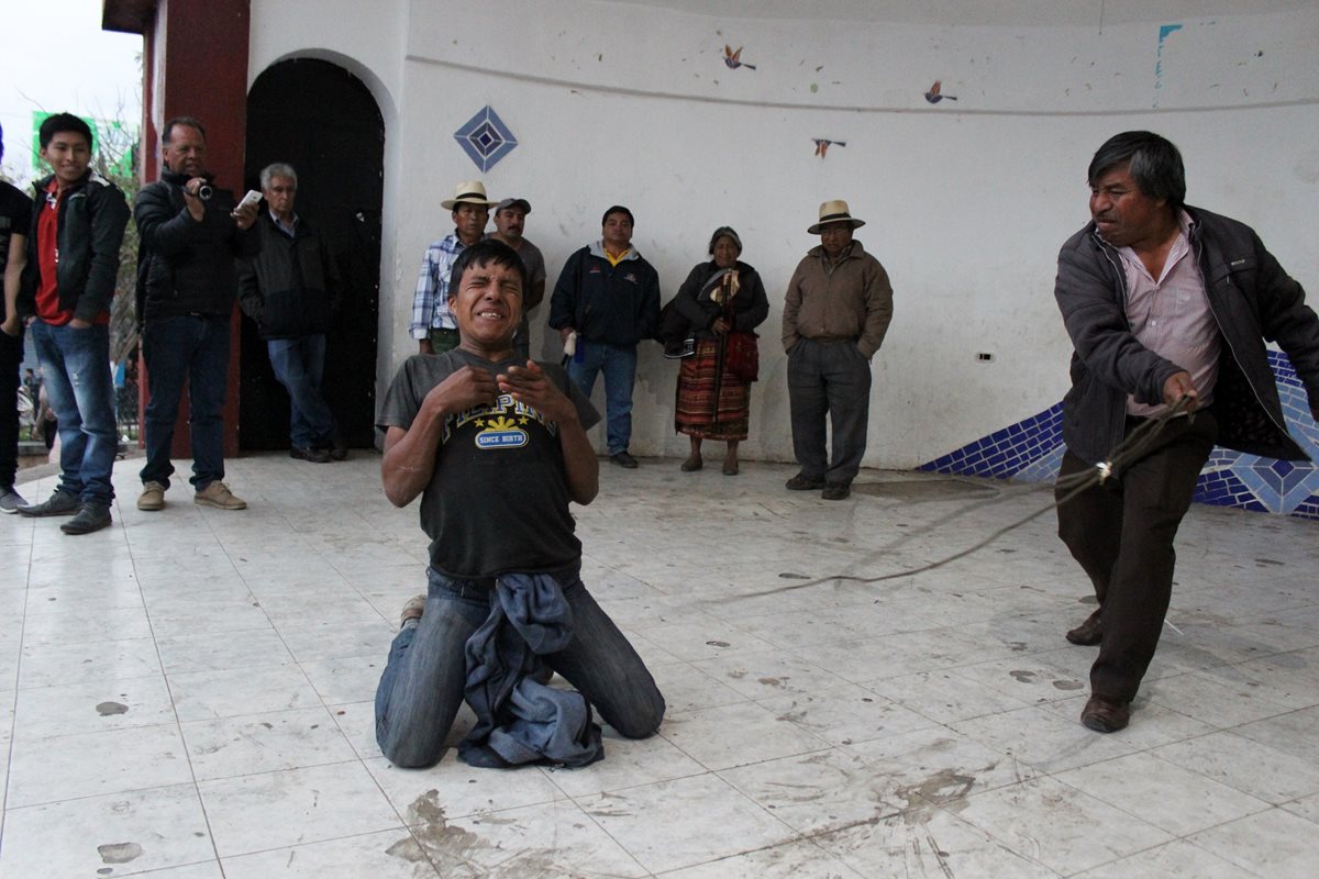 Eduardo Sebastián Tzarax Tipaz recibe azotes por parte del alcalde indígena. (Foto Prensa Libre: Óscar Figueroa)