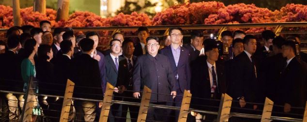 Kim Jong-un (c) camina junto a su comitiva durante una visita al puente Jubilee en la Esplanada de Singapur. (Foto Prensa Libre:AFP).