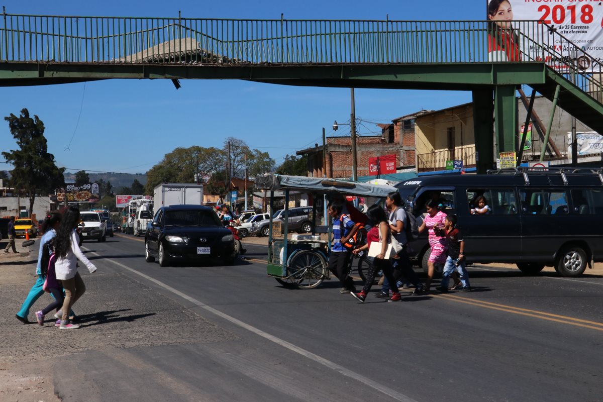 Vecinos ponen en riesgo su vida al cruzar la carretera, ante la falta de pasarela. (Foto Prensa Libre: Víctor Chamalé)