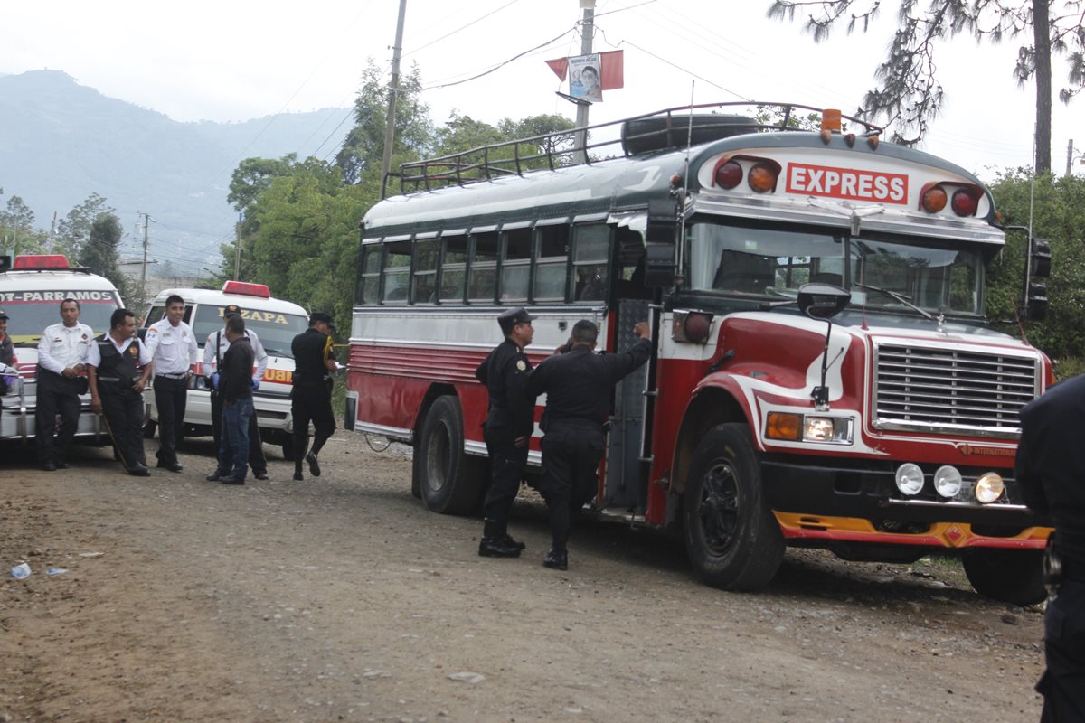 Agentes de la PNC resguardan evidencias dentro de autobús en el que murieron dos hombres, en Chimaltenango. (Foto Prensa Libre: Víctor Chamalé)