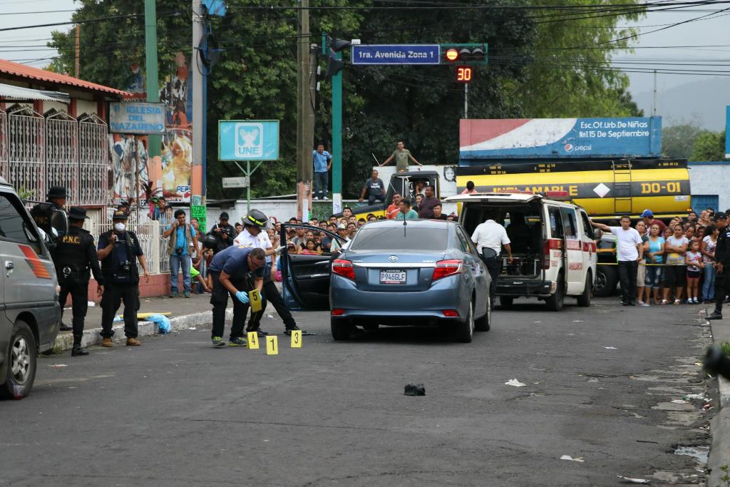 Peritos del Ministerio Público recaban evidencias en el lugar donde murió baleada la abogada Ana Beatriz Figueroa Prado, en la zona 1 de Escuintla. (Foto Prensa Libre: Enrique Paredes)