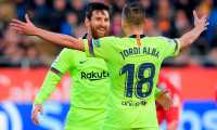 Barcelona's Argentinian forward Lionel Messi (L) celebrates with Barcelona's Spanish defender Jordi Alba after scoring a goal during the Spanish league football match between Girona FC and FC Barcelona at the Montilivi stadium in Girona on January 27, 2019. (Photo by LLUIS GENE / AFP)