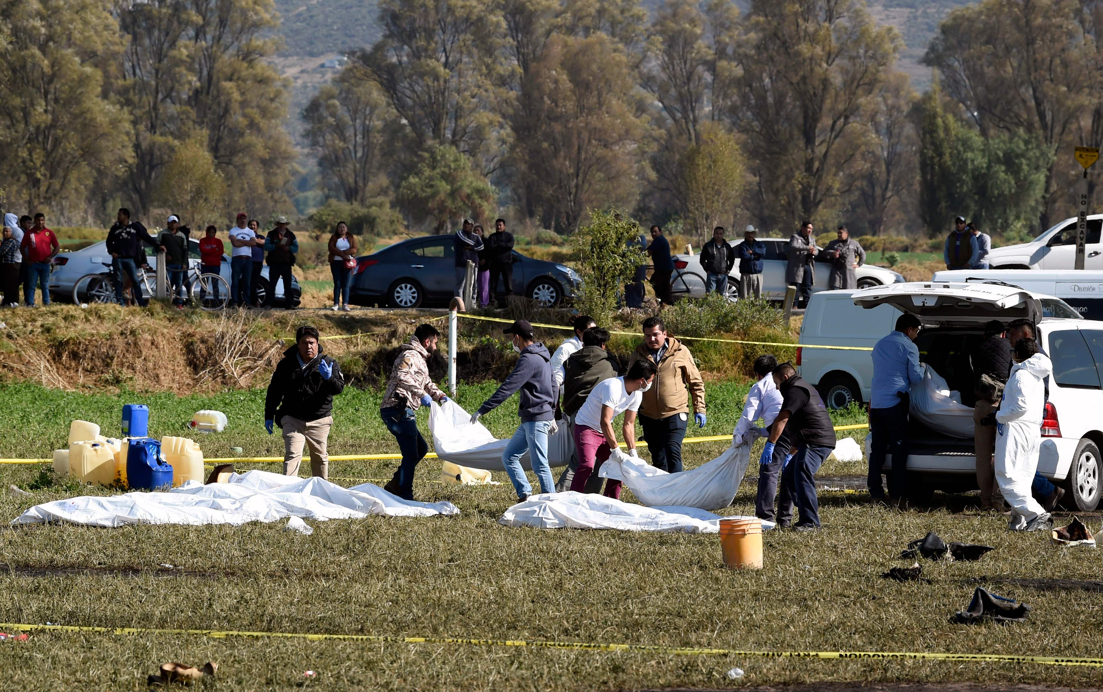 Técnicos forenses retiran  cuerpos del sitio donde explotó un ducto de combustible roto por presuntos ladrones de petróleo, en el municipio de Tlahuelilpan, estado de Hidalgo, México. (Foto Prensa Libre: AFP)