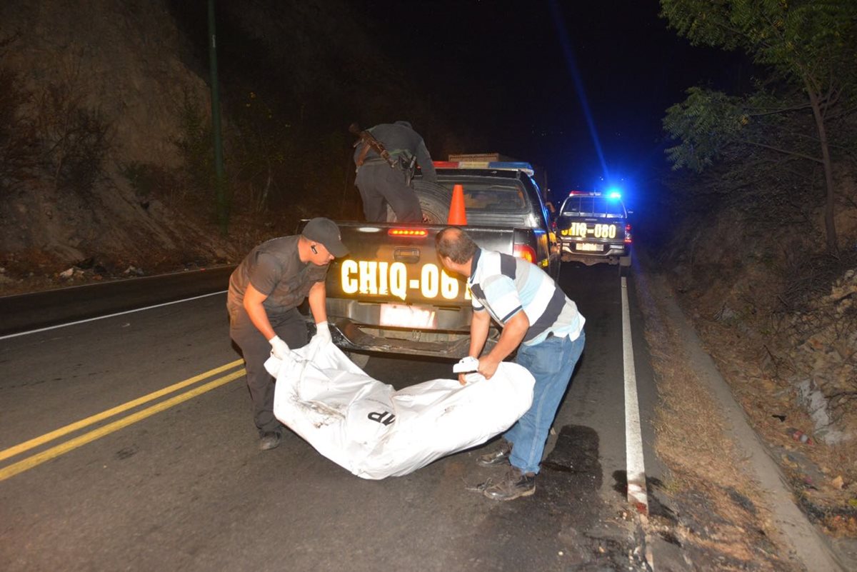 El cadáver carbonizado de un hombre, localizado en la ruta entre Chiquimula y Zacapa, es retirado del lugar donde fue abandonado. (Foto Prensa Libre: Víctor Gómez)