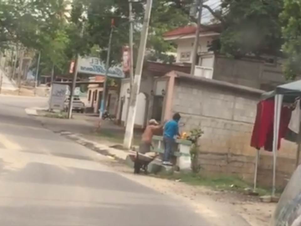 Un sujeto es acompañado por un joven a un puente en la zona 6 de la cabecera de Chiquimula, donde lanzan basura hacia el río Tacó. (Foto Prensa Libre: El Gráfico de Oriente)