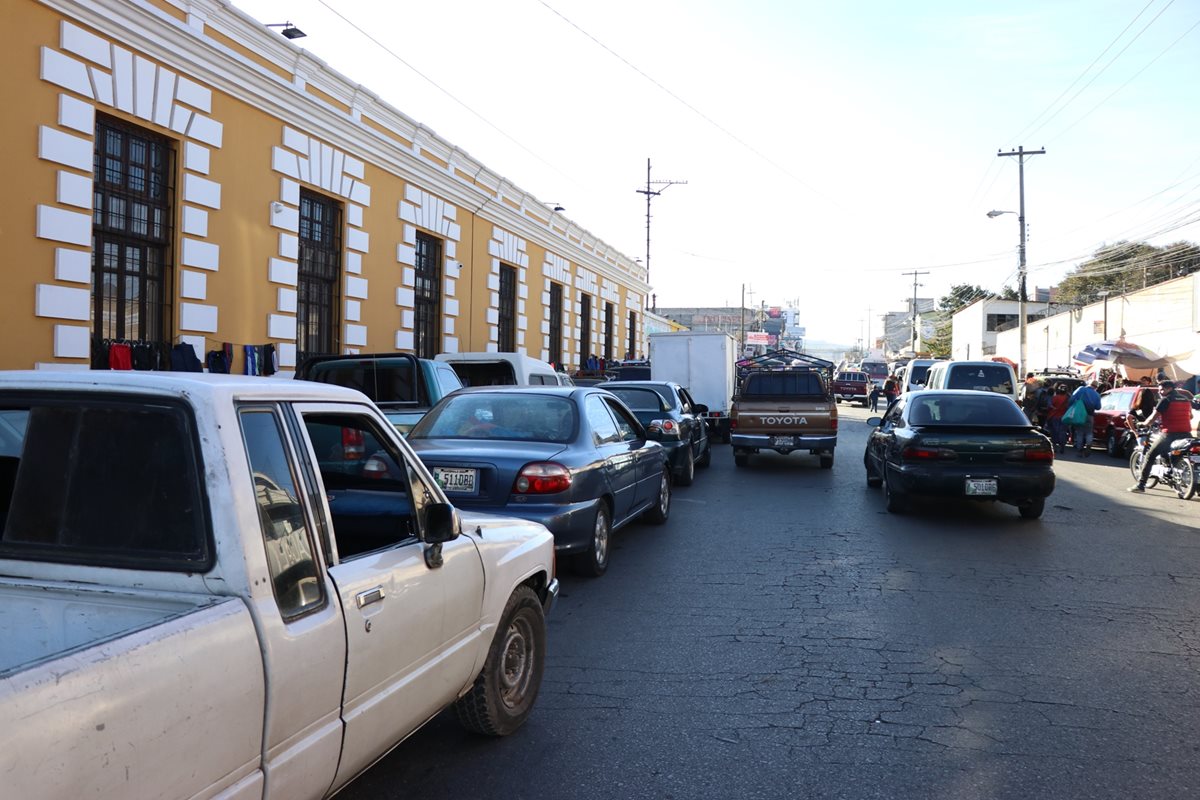 En los alrededores del mercado La Democracia, los vehículos forman dos y hasta tres filas para estacionarse, lo que causa caos vial. (Foto Prensa Libre: María José Longo)
