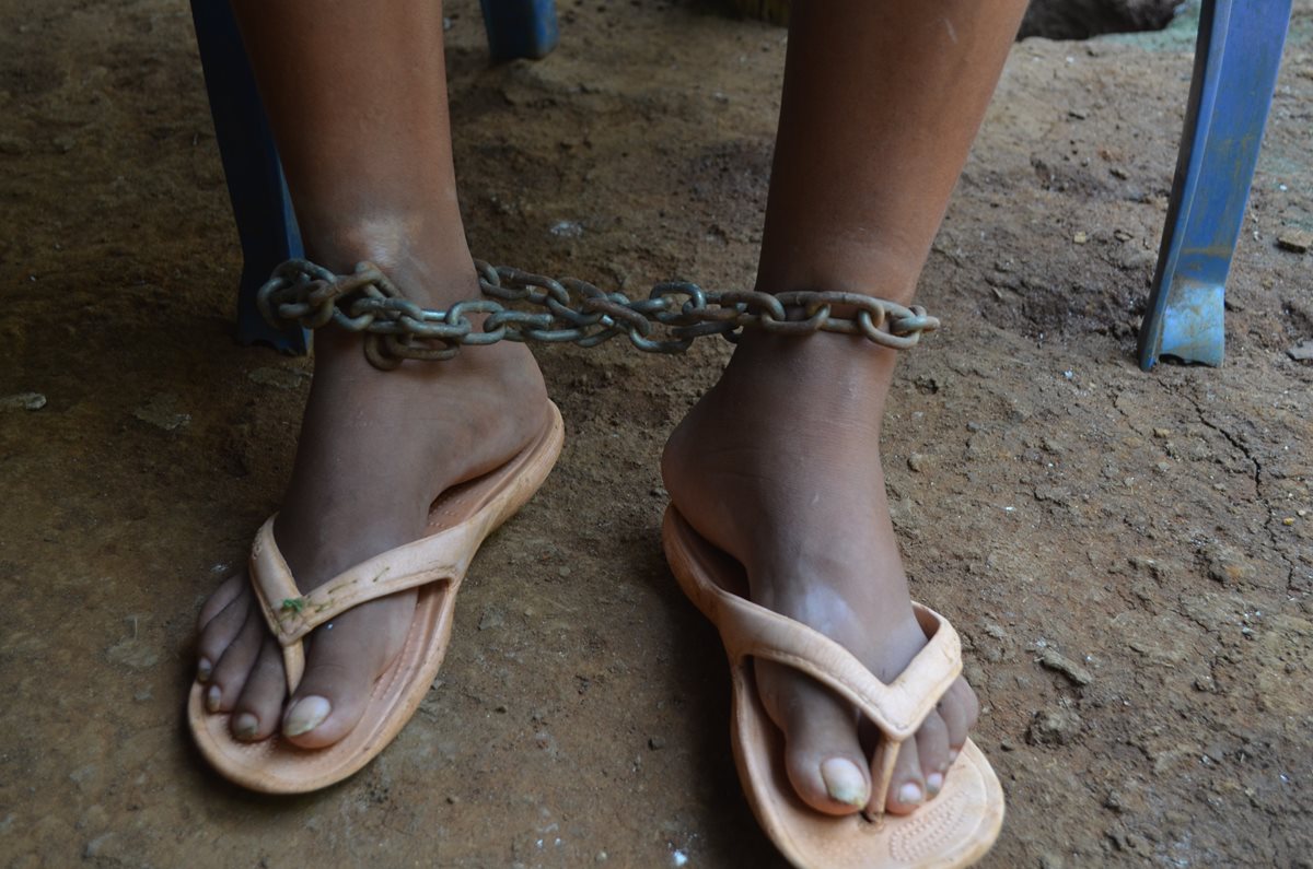Una cadena es utilizada para mantener inmóvil a una mujer en Nuevo San Carlos, Retalhuleu. (Foto Prensa Libre: Jorge Tizol)