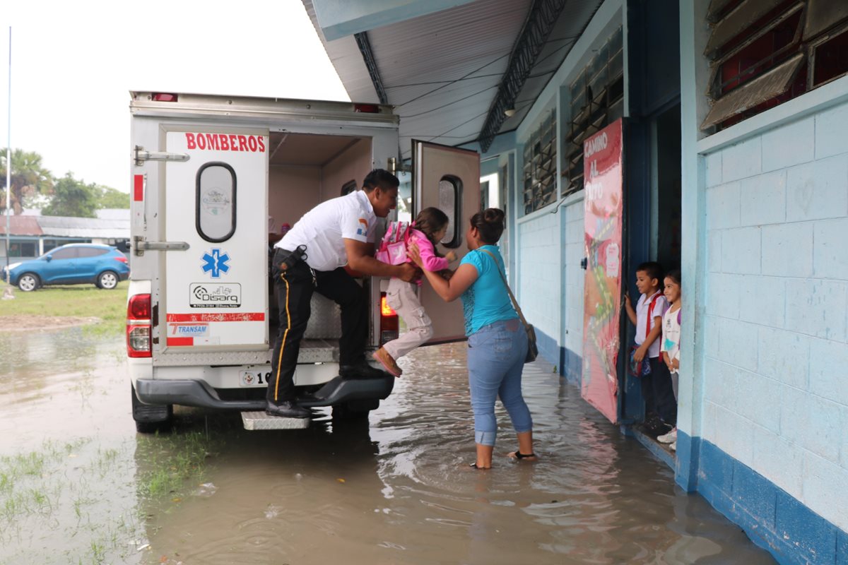 Una maestra pone fuera de riesgo a una niña en la escuela de la comunidad Ixlú. (Foto Prensa Libre: Rigoberto Escobar)
