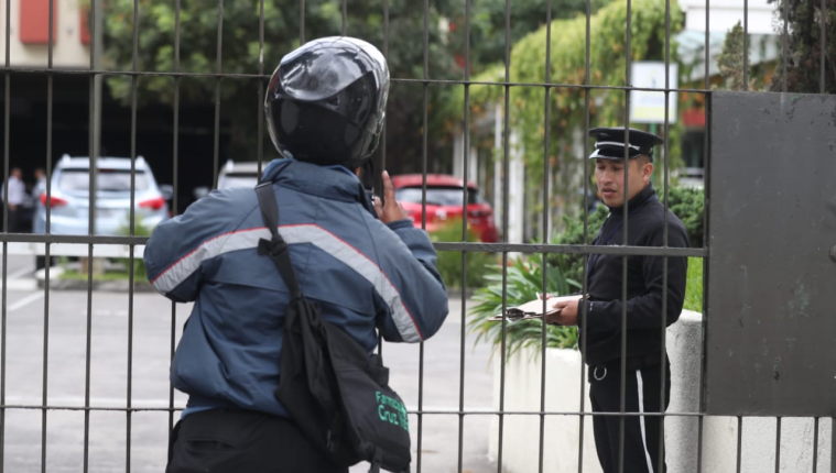 Un mensajero consulta a un guardia de seguridad si alguien podría recibirle unos documentos, pero la respuesta fue negativa. (Foto Prensa Libre: Óscar Rivas)