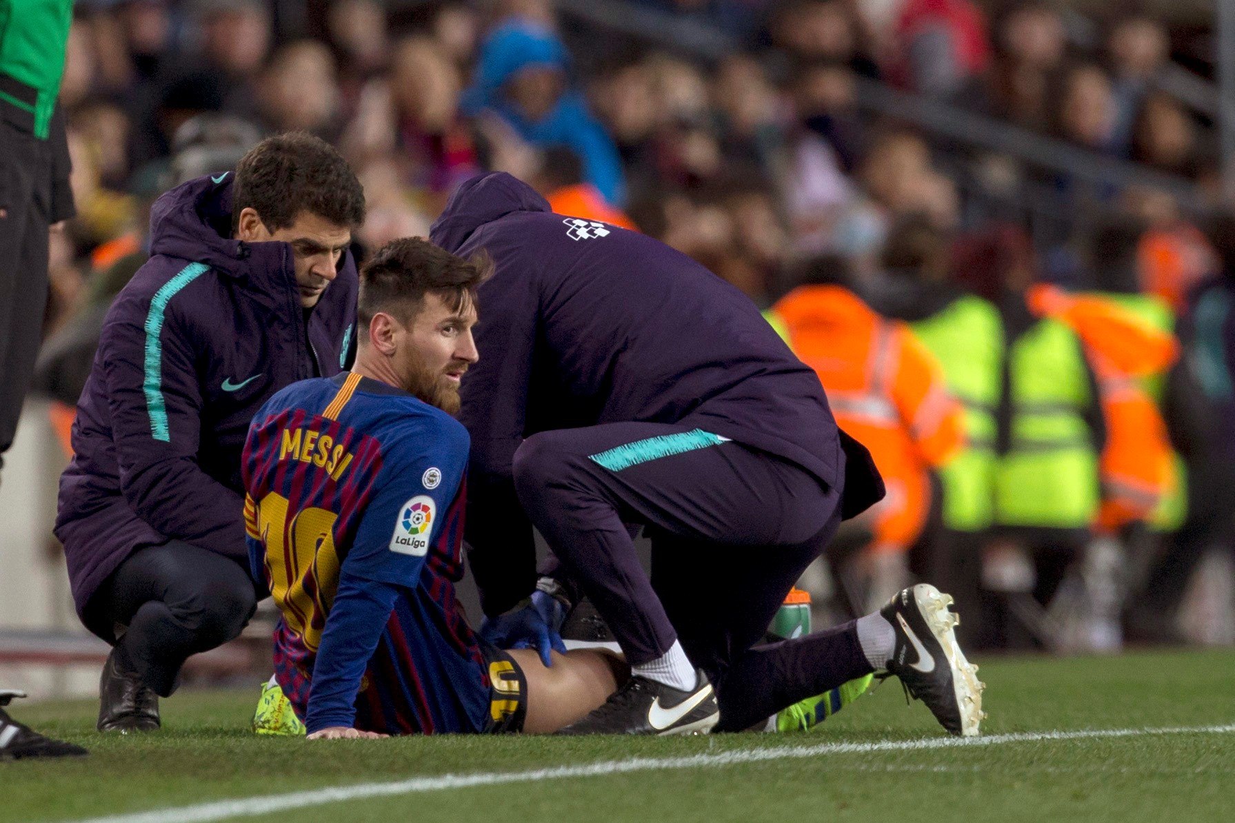El delantero argentino del FC Barcelona, Leo Messi, atendido por los fisios del equipo blaugrana. (Foto Prensa Libre: EFE)