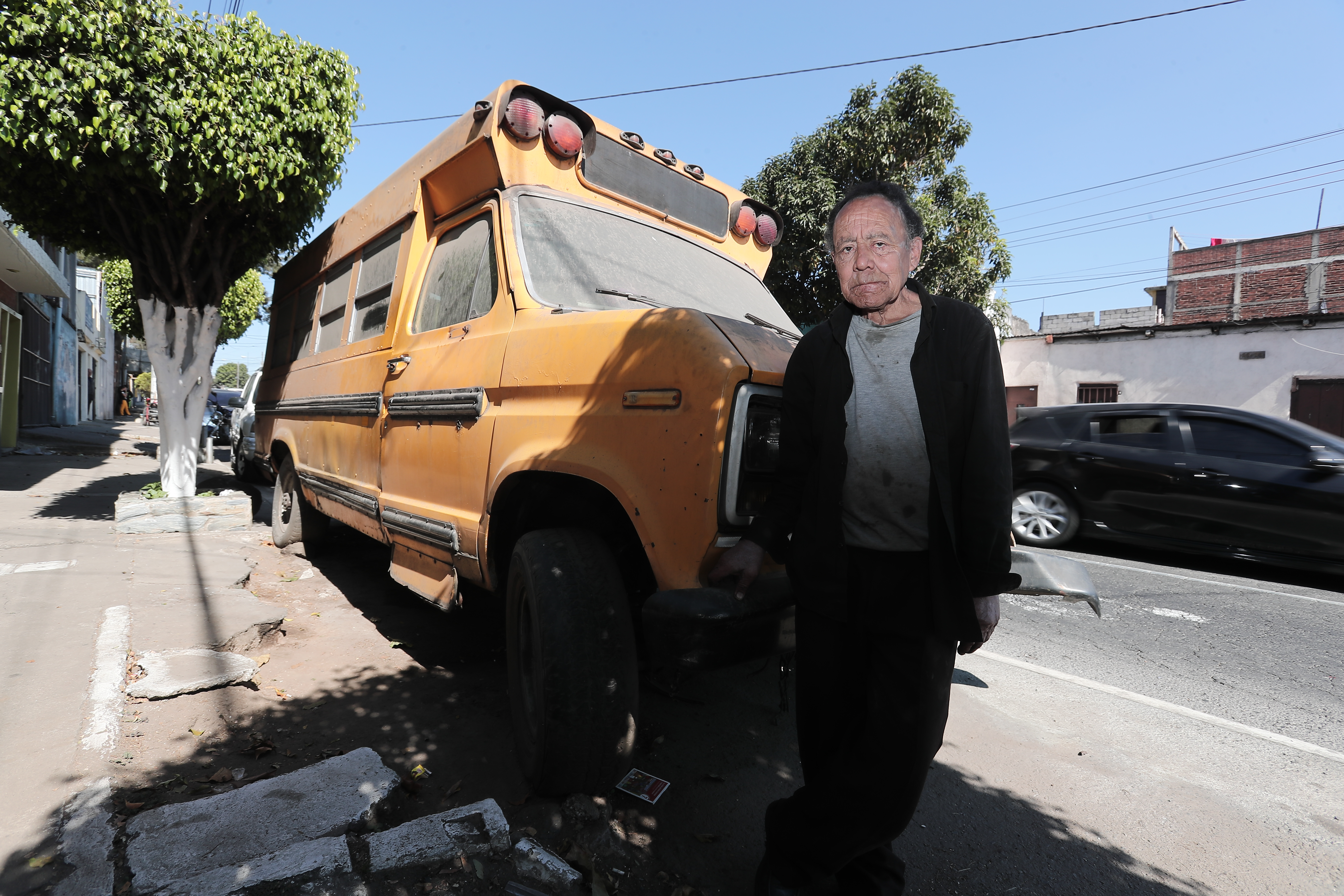 Juan Pablo Figueroa Alfaro junto al bus escolar en el que vive ene la zona 12. (Foto Prensa Libre: Juan Diego González).