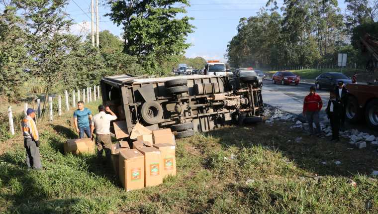 Camión que trasladaba sobres de café vuelca en la Autopista Palín-Escuintla. (Foto Prensa Libre: Hillary Paredes).