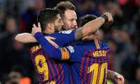 Barcelona's Uruguayan forward Luis Suarez (L) celebrates with Barcelona's Croatian midfielder Ivan Rakitic and Barcelona's Argentinian forward Lionel Messi after scoring during the Spanish league football match between FC Barcelona and Rayo Vallecano de Madrid at the Camp Nou stadium in Barcelona on March 9, 2019. (Photo by LLUIS GENE / AFP)