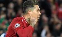 Liverpool's Brazilian midfielder Roberto Firmino celebrates after scoring a goal during the UEFA Champions League quarter-final, first leg football match between Liverpool and FC Porto at Anfield stadium in Liverpool, north-west England on April 9, 2019. (Photo by LLUIS GENE / AFP)