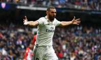 Real Madrid's French forward Karim Benzema celebrates his second goal during the Spanish League football match between Real Madrid and Athletic Bilbao at the Santiago Bernabeu Stadium in Madrid on April 21, 2019. (Photo by GABRIEL BOUYS / AFP)