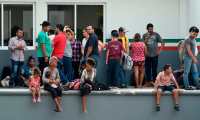 Central American migrants wait to be deported by members of the Mexican National Migration Institute (INM on spanish) inside a detention center in Tapachula, Chiapas, Mexico on April 26, 2019. - At least 1,300 mainly Cuban migrants escaped Thursday from a detention center in southern Mexico after threatening to set fire to the facility to protest against overcrowding.Since October, tens thousands of Central Americans and Cubans have traversed Mexico in so-called "caravans" in the hope of obtaining sanctuary in the United States. (Photo by ALFREDO ESTRELLA / AFP)