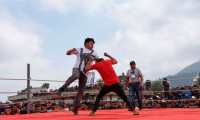 Competitors fight during a traditional bare knuckle boxing tournament at the Chivarreto village, Totonicapan departament, 205 km west of Guatemala city on April 19, 2019. - Improvised fighters box with a clean fist in a centennial tradition to commemorate Good Friday and the crucifixion of Jesus. (Photo by Johan ORDONEZ / AFP)