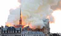 Smoke and flames rise during a fire at the landmark Notre-Dame Cathedral in central Paris on April 15, 2019, potentially involving renovation works being carried out at the site, the fire service said. (Photo by FRANCOIS GUILLOT / AFP)