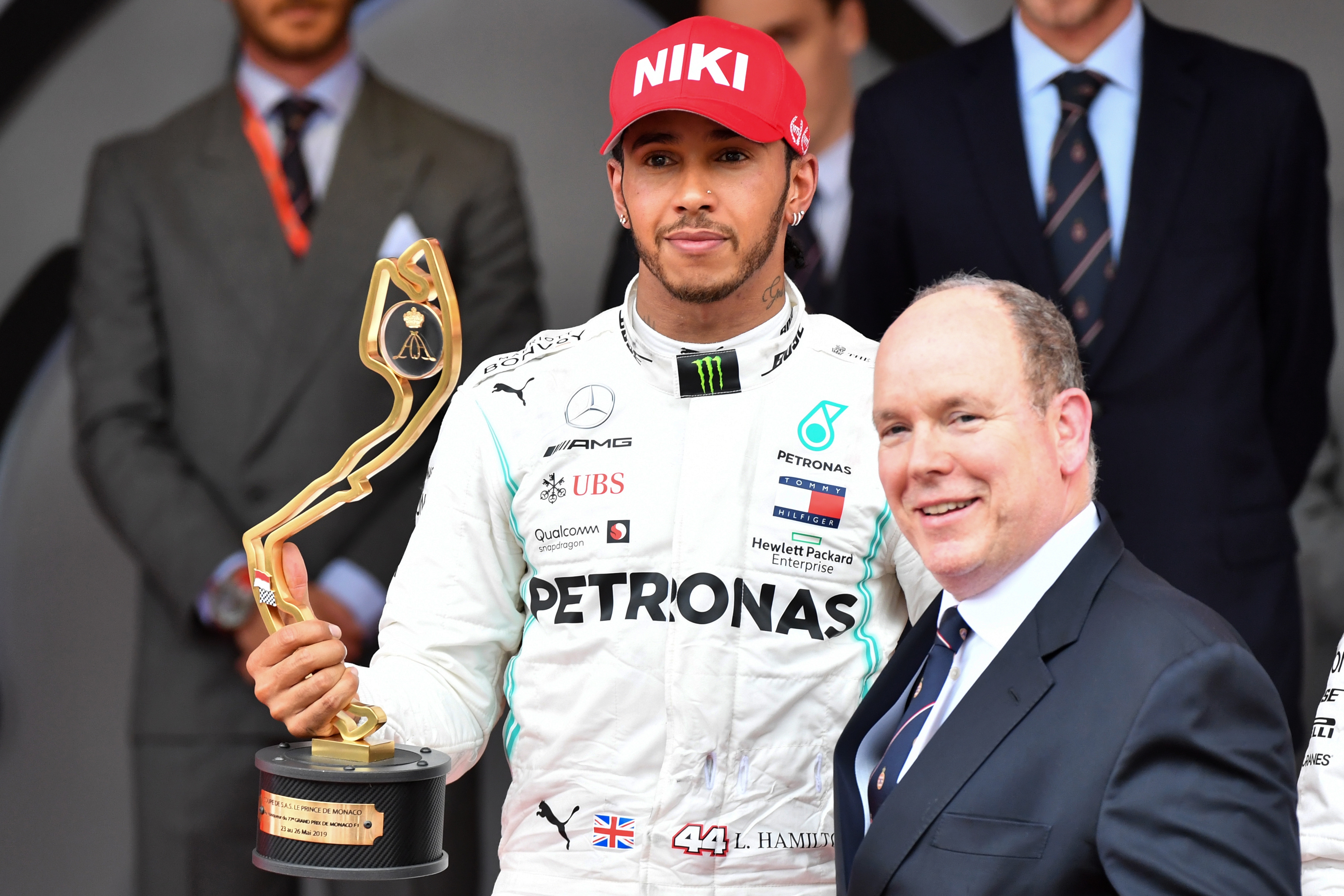 Lewis Hamilton recibe el trofeo como ganador del Gran Premio de Mónaco de manos del príncipe Alberto II. (Foto Prensa Libre: AFP)