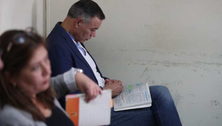 El expresidente del IGSS, Juan de Dios de la Cruz Rodríguez estuvo leyendo durante la audiencia. (Foto Prensa Libre: Carlos Hernández)