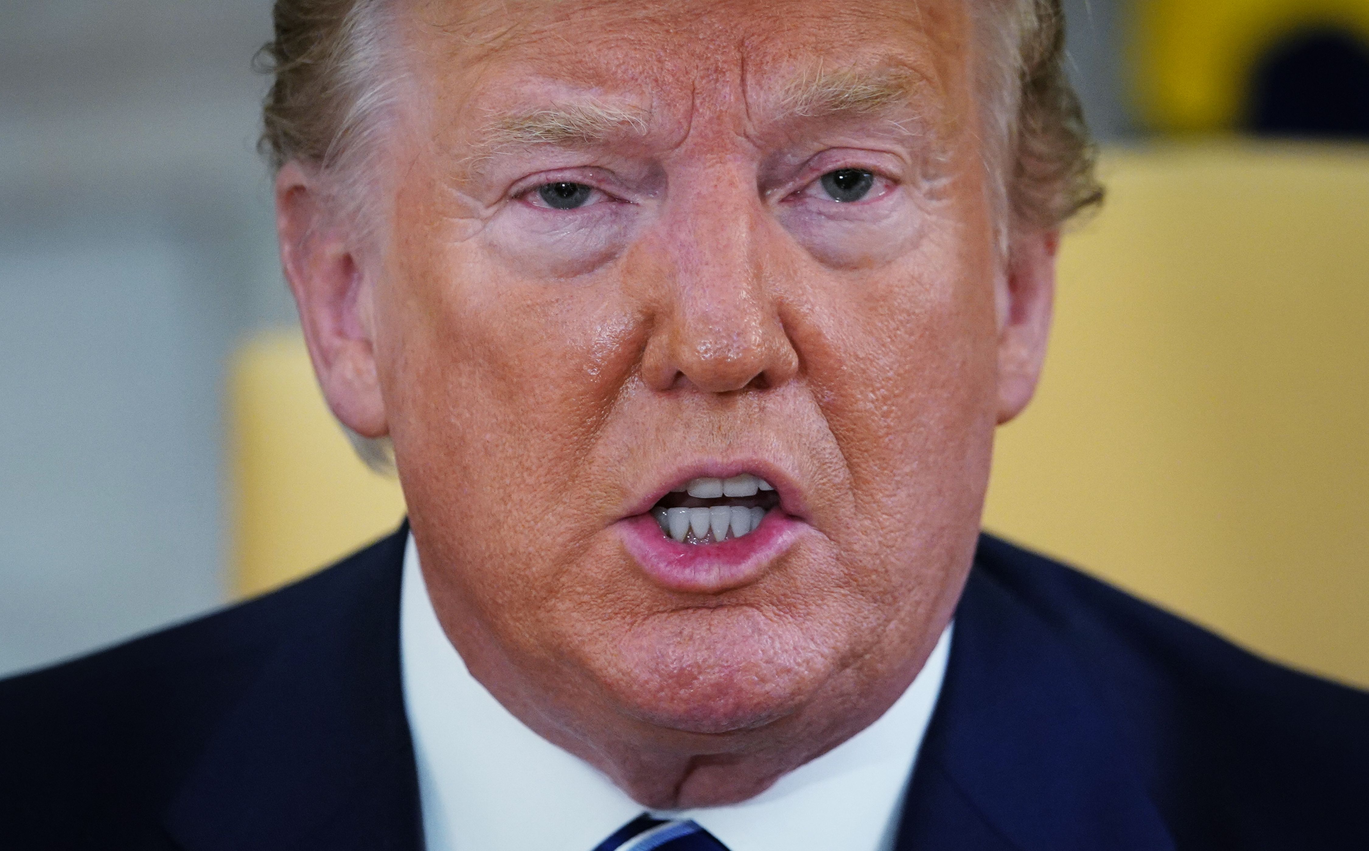 (FILES) In this file photo taken on June 20, 2019, US President Donald Trump speaks in the Oval Office of the White House in Washington, DC. - Trump said on June 21, 2019, he is in "no hurry" to bomb Iran, revealing that US forces were "cocked and loaded" but that he called them back with minutes to go in order to avoid mass casualties. "I am in no hurry," Trump said in a series of tweets detailing his thought process during the late Thursday decision to send, then recall US forces meant to retaliate for the downing by Iran of a US spy drone. (Photo by MANDEL NGAN / AFP)