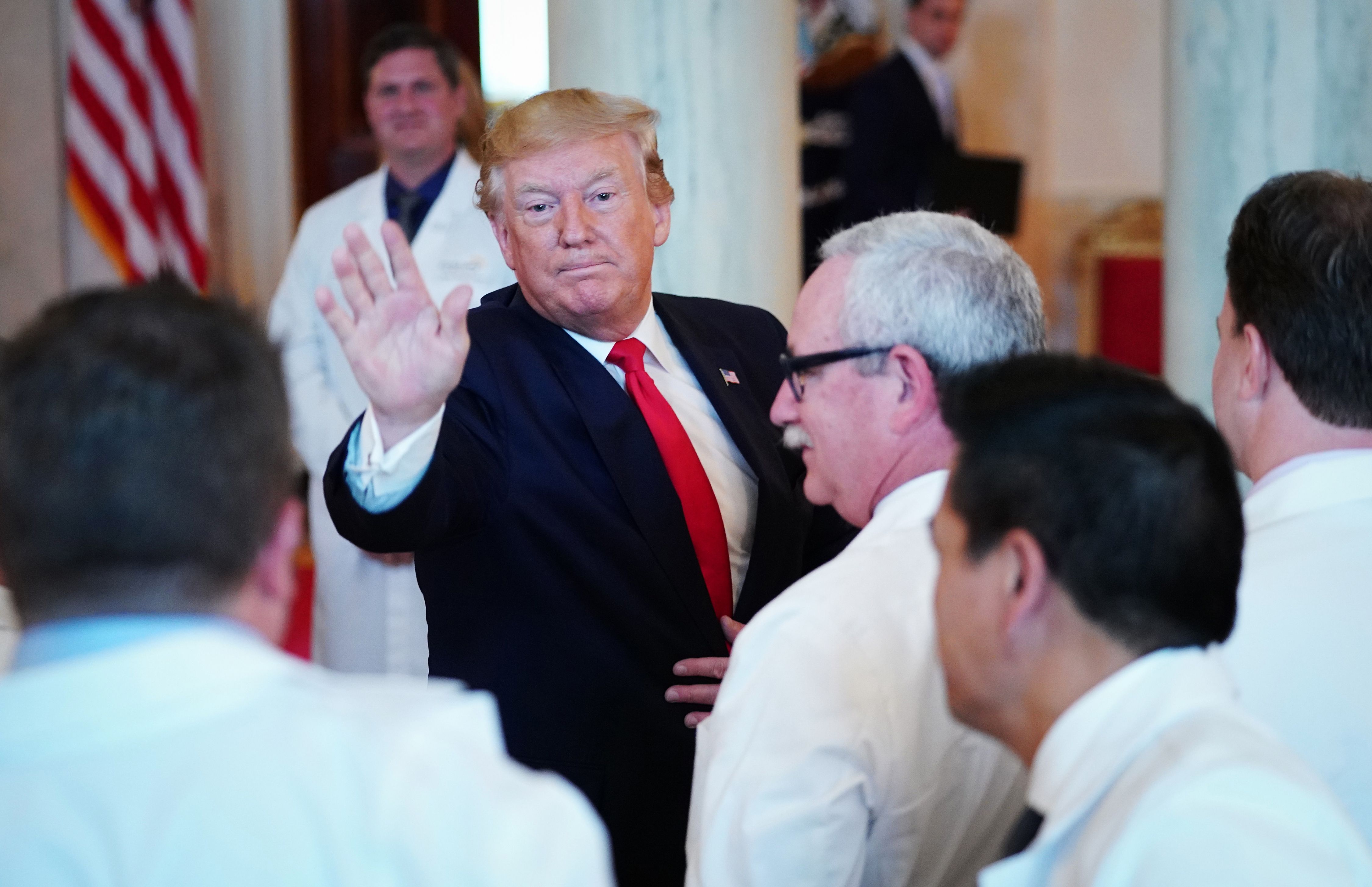 US President Donald Trump waves after signing an executive order on "improving price and quality transparency in healthcare" in the Grand Foyer of the White House in Washington, DC on June 24, 2019. (Photo by MANDEL NGAN / AFP)