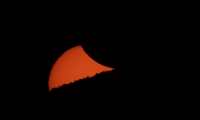 A partially eclipsed sun sets behind a mountain ridge as seen from El Molle, Chile, on July 2, 2019 after the total solar eclipse. - Tens of thousands of tourists braced Tuesday for a rare total solar eclipse that was expected to turn day into night along a large swath of Latin America's southern cone, including much of Chile and Argentina. (Photo by Stan HONDA / AFP)