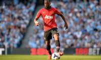 (FILES) In this file photo taken on September 22, 2013 then Manchester United's French defender Patrice Evra runs with the ball during an English Premier League football match in Manchester. - French former international Patrice Evra, 38, who played in Monaco, Manchester, Marseille, Juventus and West Ham, announced on July 29, 2019 his "carrier as a player is officially over" in the Italian Sport newspaper "Gazzetta dello Sport." (Photo by Paul ELLIS / AFP)