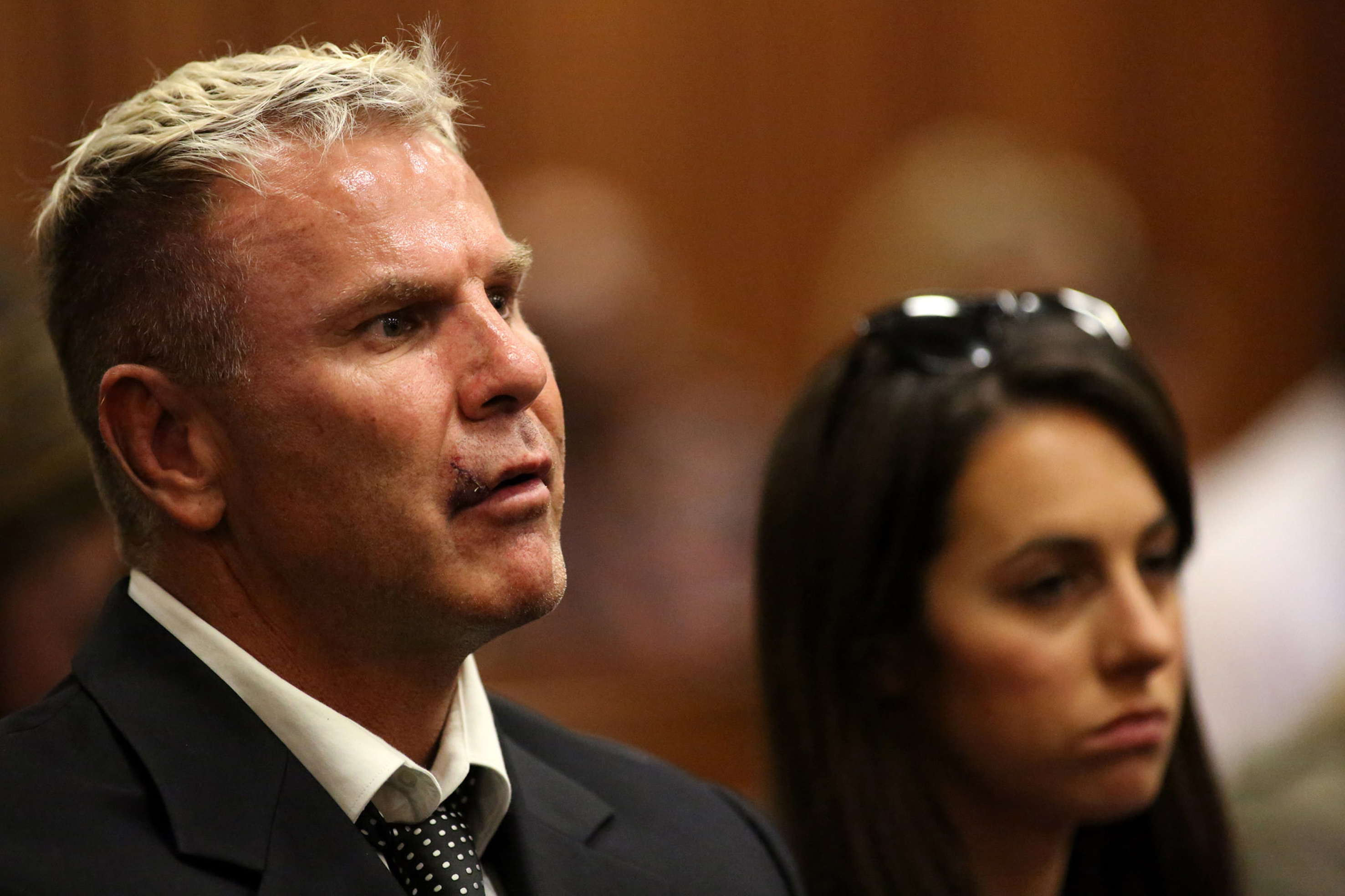 (FILES) In this file photograph taken on March 25, 2014, former South African footballer Marc Batchelor (L) and Gina Myers, friends of Reeva Steenkamp, attend the murder trial of paralympic track star Oscar Pistorius at the North Gauteng High Court in Pretoria. - Former South Africa footballer Marc Batchelor was shot dead in an apparent targeted killing late July 15, 2019, as he drove home in Johannesburg, police said. (Photo by Siphiwe SIBEKO / POOL / AFP)