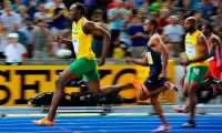 (FILES) In this file photo taken on August 16, 2009 Jamaica's Usain Bolt wins the men's 100m final race of the 2009 IAAF Athletics World Championships ahead of US Tyson Gay and Jamaica's Asafa Powell in Berlin. - Ten years ago Jamaican Usain Bolt set a world record of 9.58 seconds in winning the final of the men's 100m at the World Athletics Championships. (Photo by Fabrice COFFRINI / AFP)