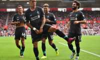 Liverpool's Brazilian midfielder Roberto Firmino (C) celebrates with teammates after scoring their second goal during the English Premier League football match between Southampton and Liverpool at St Mary's Stadium in Southampton, southern England on August 17, 2019. (Photo by Glyn KIRK / AFP) / RESTRICTED TO EDITORIAL USE. No use with unauthorized audio, video, data, fixture lists, club/league logos or 'live' services. Online in-match use limited to 120 images. An additional 40 images may be used in extra time. No video emulation. Social media in-match use limited to 120 images. An additional 40 images may be used in extra time. No use in betting publications, games or single club/league/player publications. /