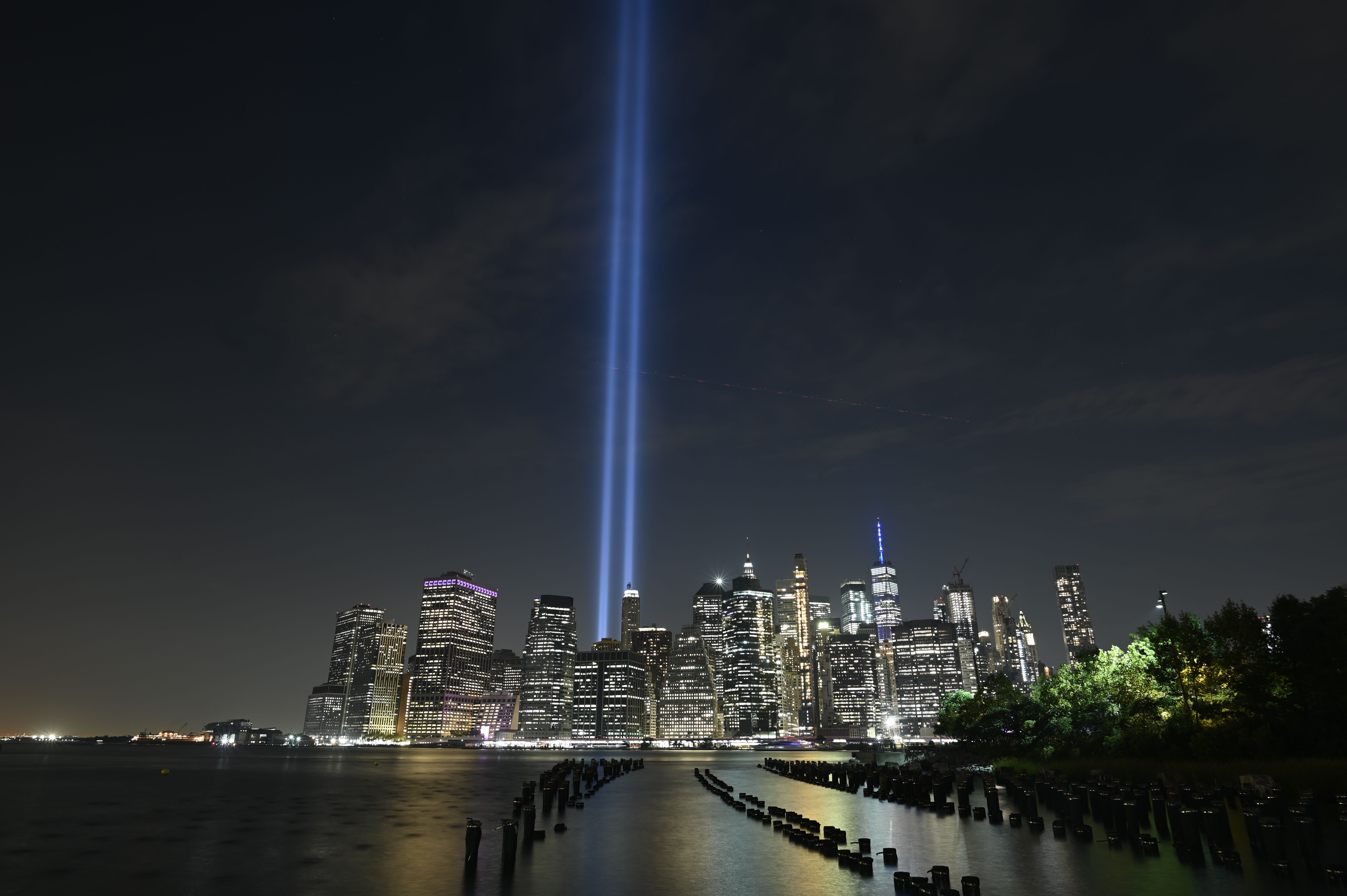 The Tribute in Light shines into the sky over Manhattan's skyline on September 11, 2019 in New York. - The art installation of 88 searchlights is marking the 18th anniversary of the 911 attacks (Photo by Johannes EISELE / AFP)