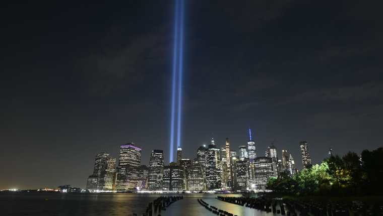 The Tribute in Light shines into the sky over Manhattan's skyline on September 11, 2019 in New York. - The art installation of 88 searchlights is marking the 18th anniversary of the 911 attacks (Photo by Johannes EISELE / AFP)