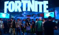 (FILES) In this file photo taken on June 12, 2018, people crowd the display area for the survival game Fortnite at the 24th Electronic Expo, or E3 2018, in Los Angeles, California. - Internet gaming phenomenon Fortnite has temporarily gone offline, leaving millions of addicted gamers wondering what to do with themselves, after a massive asteroid brought the latest season to an end. Epic Games, Fortnite's creators, announced that season ten of the shoot-'em-up survival video game would end on October 13, 2019 and many users expected season eleven to follow immediately. (Photo by Frederic J. BROWN / AFP)