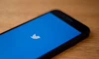 (FILES) In this file photo taken on July 10, 2019 the Twitter logo is seen on a phone in this photo illustration in Washington, DC. - Twitter said on October 30, 2019 that it would stop accepting political advertising globally on its platform, responding to growing concerns over misinformation from politicians on social media. (Photo by Alastair Pike / AFP)