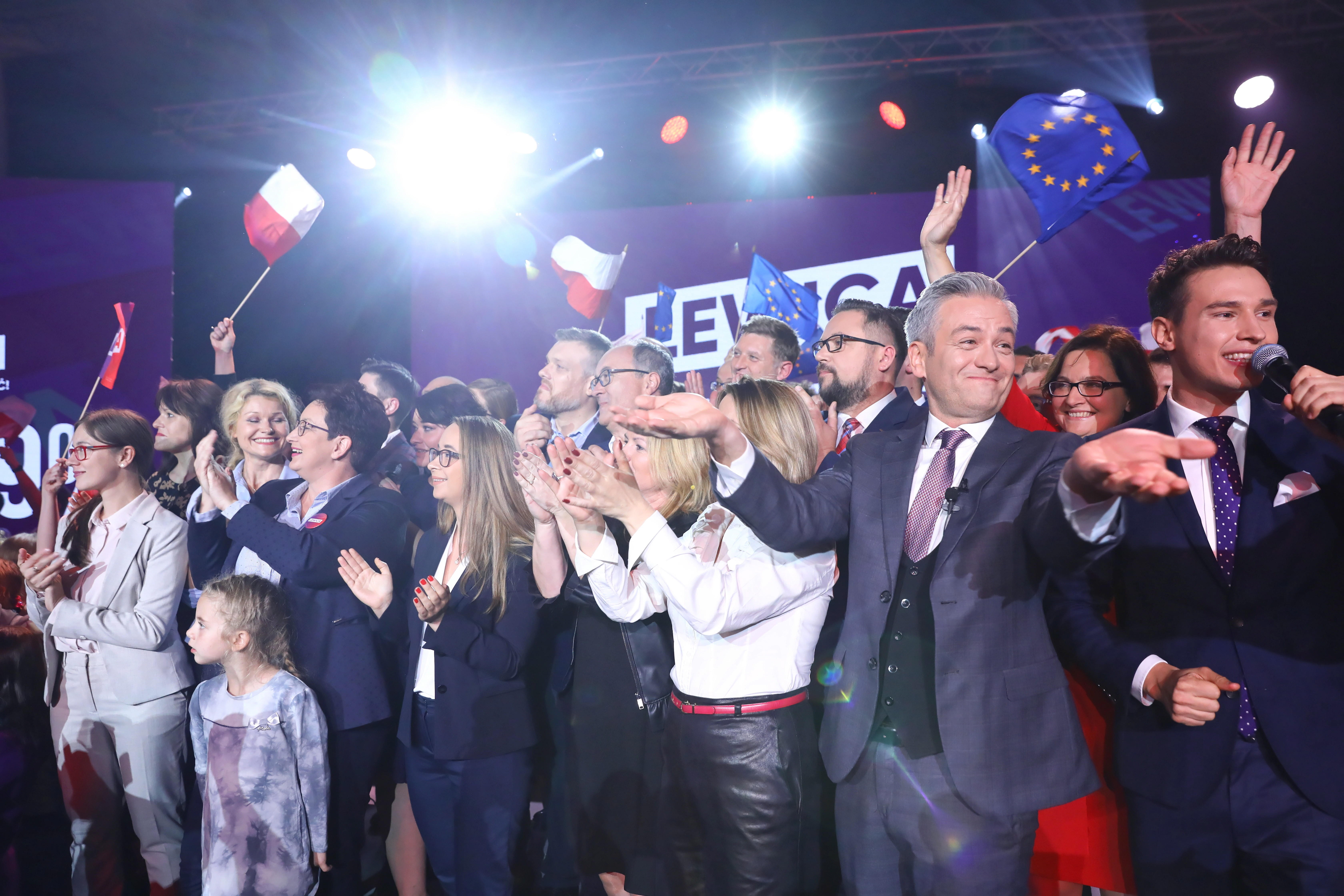 Warsaw (Poland), 13/10/2019.- Robert Biedron (2R) of Left bloc party react during parliamentary elections night in Warsaw, Poland, 13 October 2019. An average of eleven candidates are running for each Sejm (lower house) seat in the national elections. In total, 5,114 people are running for 460 seats. Two hundred and seventy-eight people are running for the Senate (upper house), three candidatures for each seat. Five electoral committees were registered in all 41 constituencies, namely, the ruling Law and Justice (PiS) party, Poland's main opposition bloc the Civic Coalition (KO), the Polish People's Party (PSL) with the Kukiz'15 party, the Confederation Freedom and Independence and the Left (Lewica) bloc comprising liberal and left-wing parties the Democratic Left Alliance (SLD), Spring and Together. (Elecciones, Polonia, Varsovia) EFE/EPA/Rafal Guz POLAND OUT