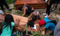 Relatives and friends mourn at the burial of Johander Perez and Wuilkerman Ruiz, at the General South Cementery in Caracas, Venezuela, on November 5, 2019. - Perez and Ruiz were allegedly killed by the Bolivarian National Polices Special Action Forces (FAES) on November 1, 2019. UN High Commissioner for Human Rights Michelle Bachelet issued a report last July pointing a finger at Venezuelas FAES calling to dissolve the organization suspected of carrying out numerous extrajudicial executions. (Photo by STR / AFP)