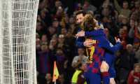 Barcelona's Argentine forward Lionel Messi (up) celebrates with teammate Barcelona's French forward Antoine Griezmann after scoring a goal during the UEFA Champions League Group F football match between FC Barcelona and Borussia Dortmund at the Camp Nou stadium in Barcelona, on November 27, 2019. (Photo by Josep LAGO / AFP)
