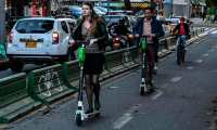 People ride electric scooters in Bogota on June 26, 2019. - The use of the increasingly-popular electric scooters, which offer a quick and cheap way to get around, is causing safety concerns in cities across Latin America. Critics say they pose a grave safety risk both for users and pedestrians while authorities in some countries have started implementing some kind of framework for their use. (Photo by Juan BARRETO / AFP)