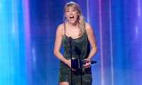 LOS ANGELES, CALIFORNIA - NOVEMBER 24: Taylor Swift accepts the Favorite Album - Pop/Rock award for 'Lover' performs onstage during the 2019 American Music Awards at Microsoft Theater on November 24, 2019 in Los Angeles, California.   JC Olivera/Getty Images/AFP
== FOR NEWSPAPERS, INTERNET, TELCOS & TELEVISION USE ONLY ==