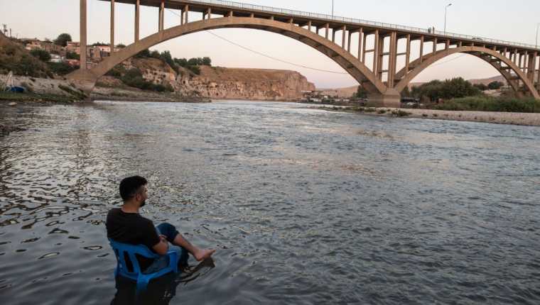La calma antes de la tormenta. Un hombre descansa en la orilla del Tigris, mientras las aguas, suben lentamente hasta sumergir a su pueblo, perdiéndose así uno de los lugares habitados más antiguos del mundo.