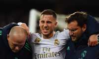 (FILES) In this file photo taken on November 26, 2019 Real Madrid's Belgian forward Eden Hazard gestures in pain during the UEFA Champions League group A football match Real Madrid against Paris Saint-Germain FC at the Santiago Bernabeu stadium in Madrid. - Eden Hazard is set to miss the Clasico against Barcelona after further tests revealed a fracture in his right ankle, Real Madrid confirmed on December 5, 2019. (Photo by GABRIEL BOUYS / AFP)