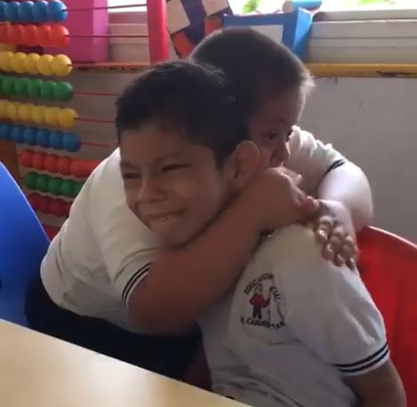 Un niño con síndrome de Donw consuela a su amigo con autismo. (Foto Prensa Libre: Tomado de Youtube)