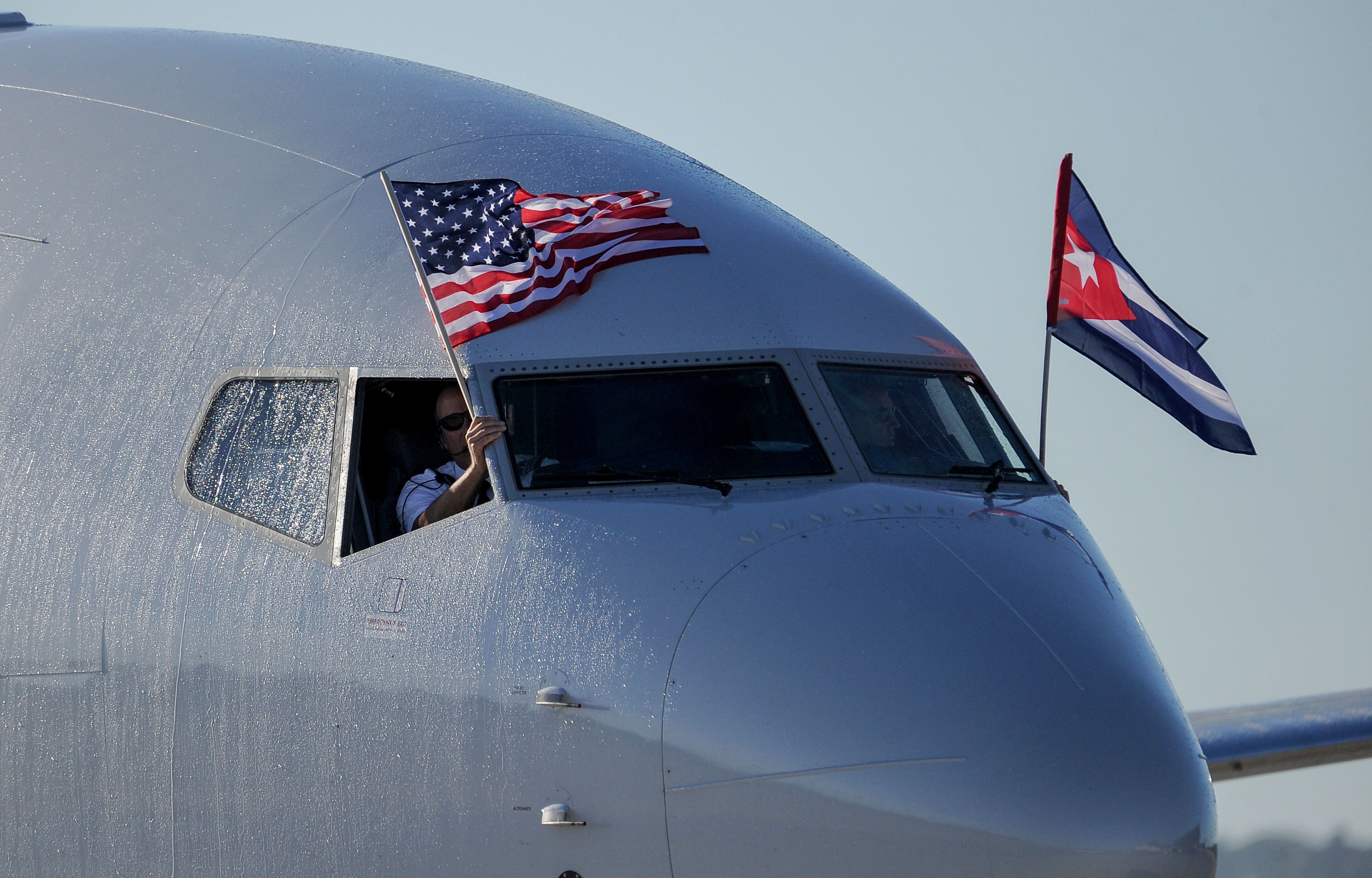 (FILES) In this file photo taken on November 28, 2016, an American Airlines plane fluttering US and Cuba national flags arrives at Jose Marti International Airport in Havana, becoming the first Miami-Havana commercial flight in 50 years. - The US on January 10, 2020, sharply reduced flights allowed to go to Cuba in a bid to reduce tourism revenue to the communist island. US Secretary of State Mike Pompeo said that charter flights would only be allowed to fly to Havana, not other airports -- a step already taken with commercial flights. (Photo by YAMIL LAGE / AFP)