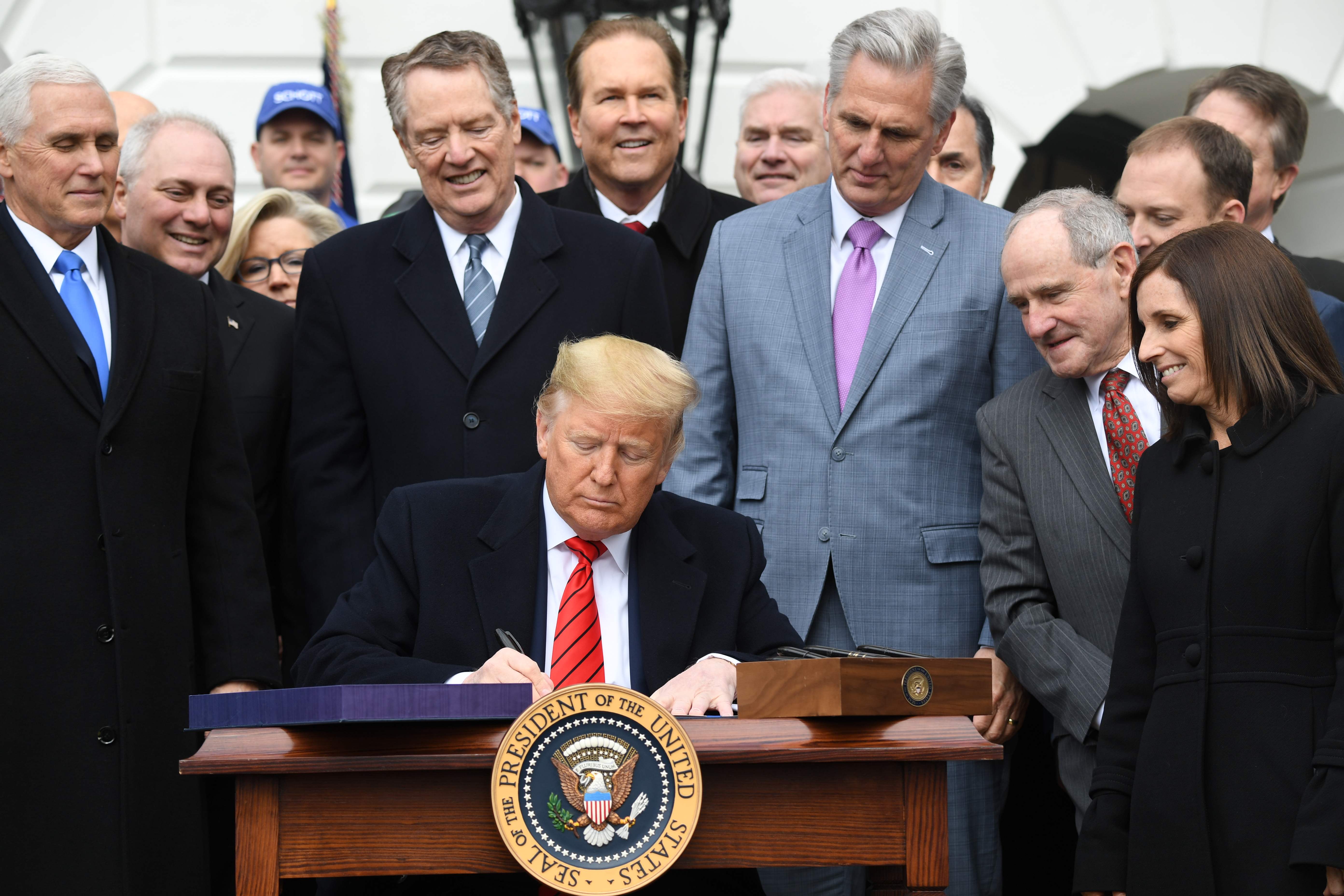 US President Donald Trump signs the United States - Mexico -Canada Trade Agreement, known as USMCA, during a ceremony on the South Lawn of the White House in Washington, DC, January 29, 2020. - The USMCA, the fruit of years of negotiation between the three key trading partners, is billed as an update to the 1994 North American Free Trade Agreement, which Trump had long lambasted as a job killer and threatened to scrap outright. (Photo by SAUL LOEB / AFP)