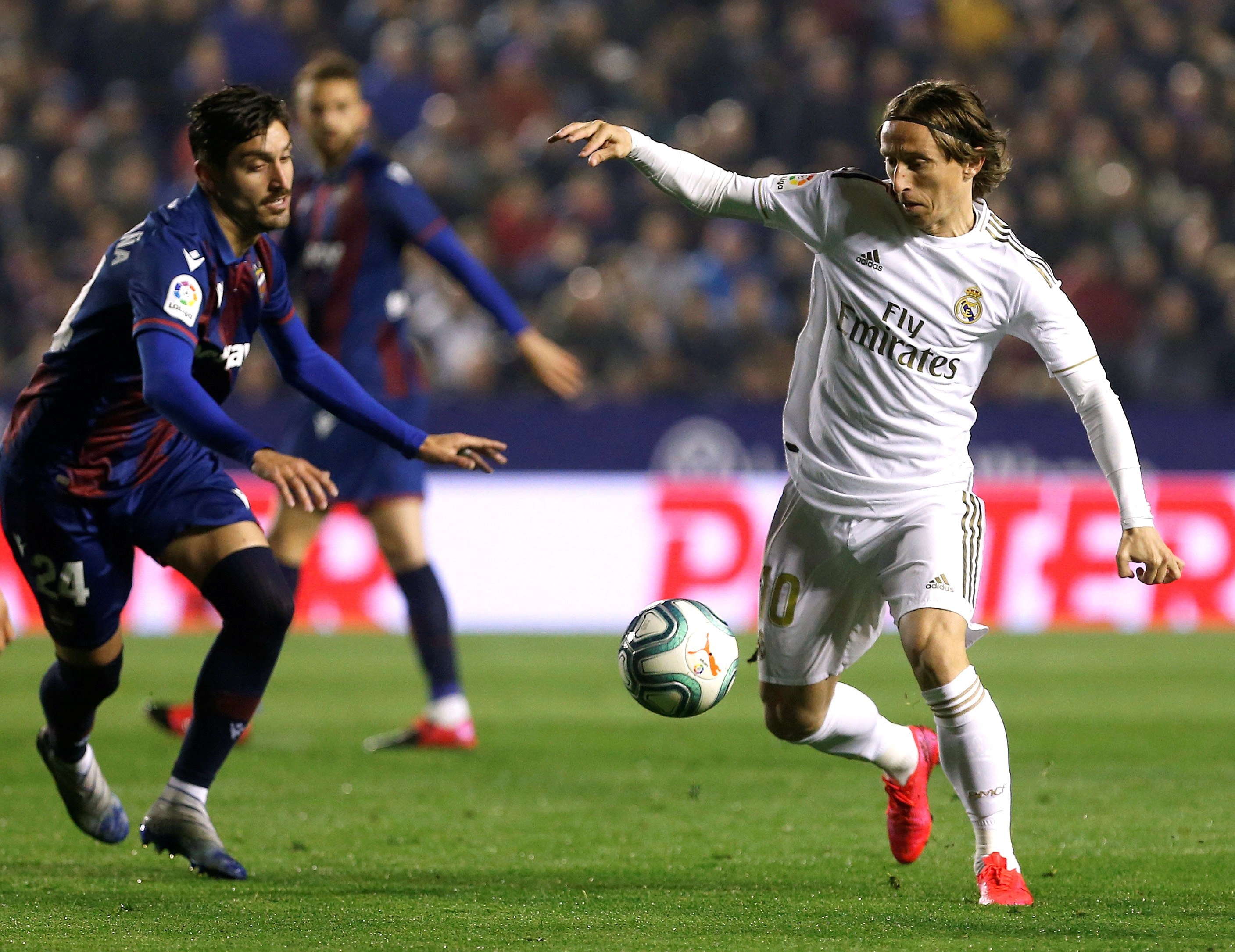 El centrocampista del Real Madrid Luka Modric juega un balón ante José Campaña, del Levante. (Foto Prensa Libre: EFE)